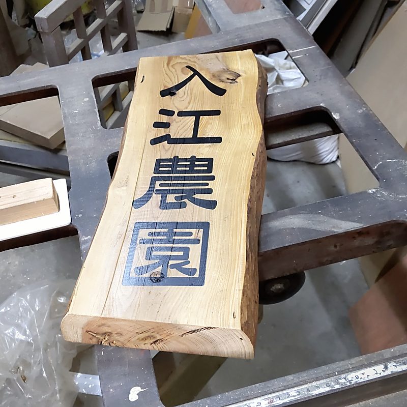 杉の一枚板に濃紺の文字を入れた農園の木製看板